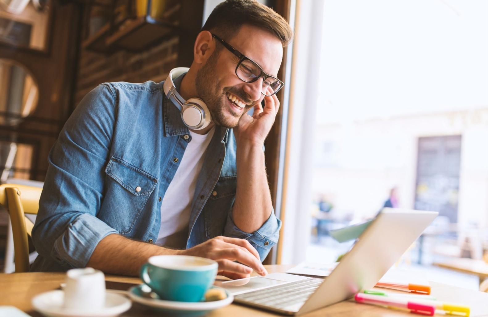 Student reviewing investment automation materials with laptop and notebook